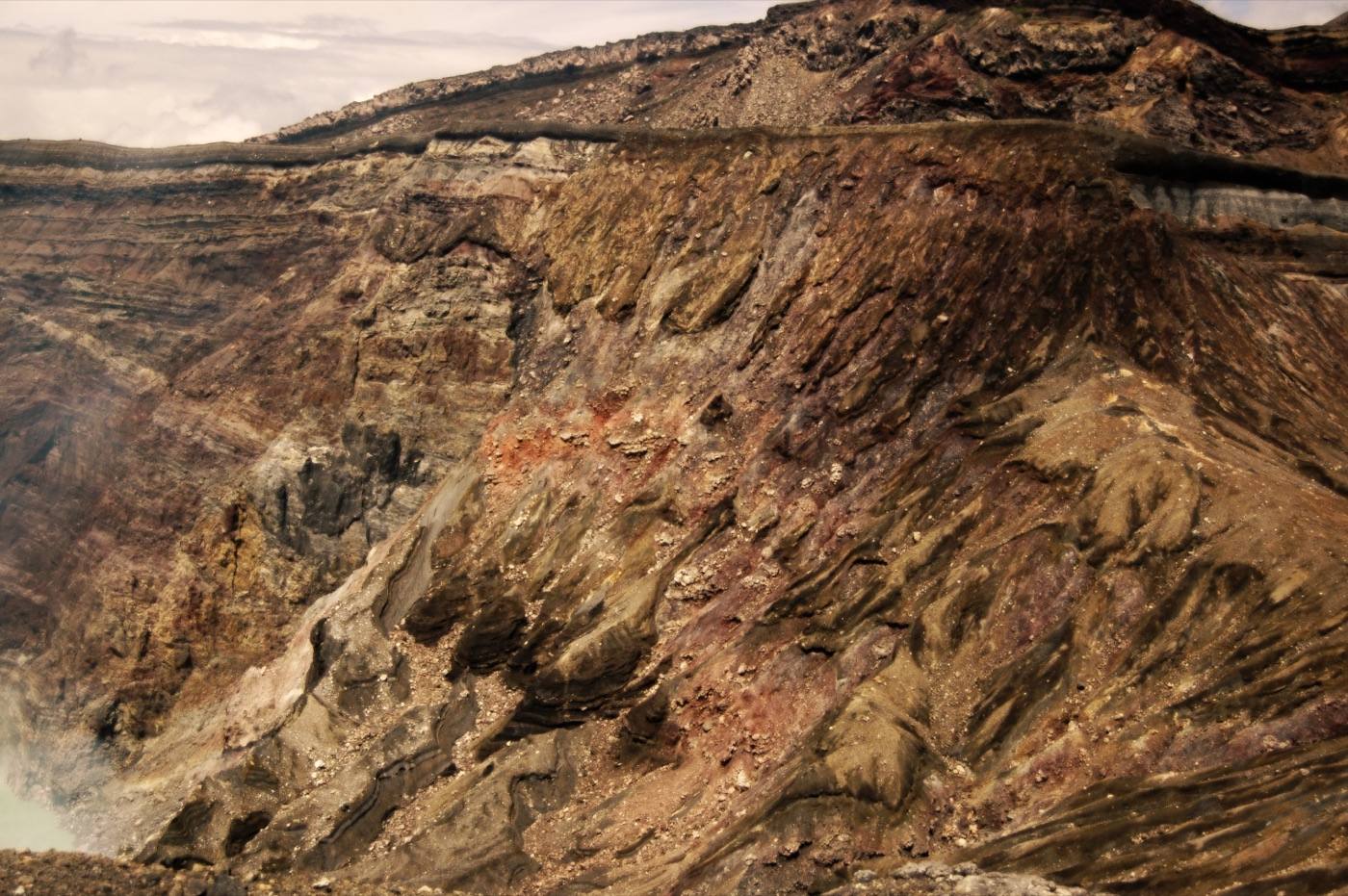 a volcanic crater with rising steam