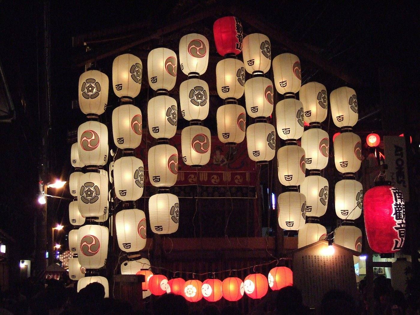 a Gion Matsuri float lit by lanterns