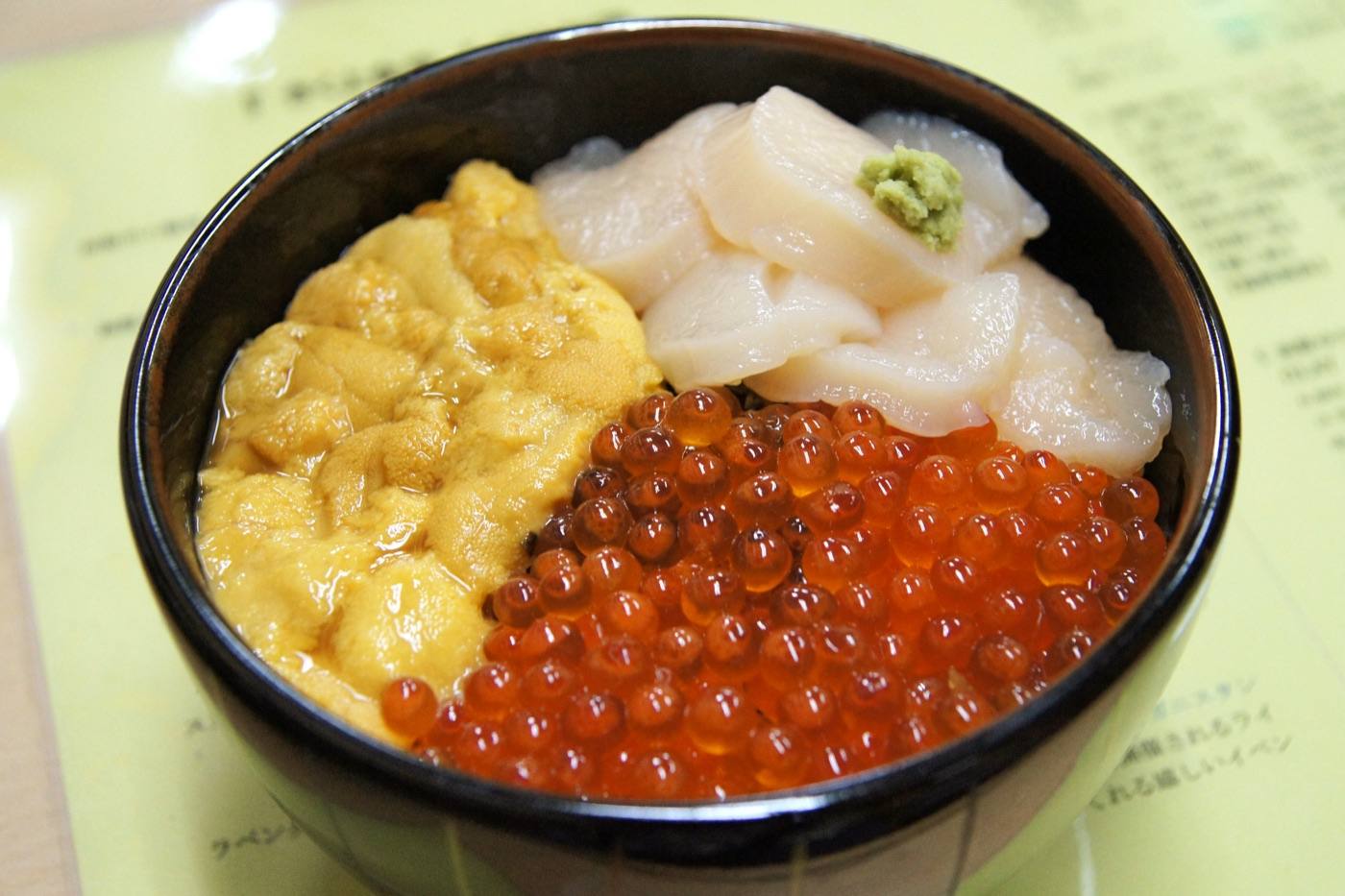 a bowl of sea urchin, salmon roe and scallop